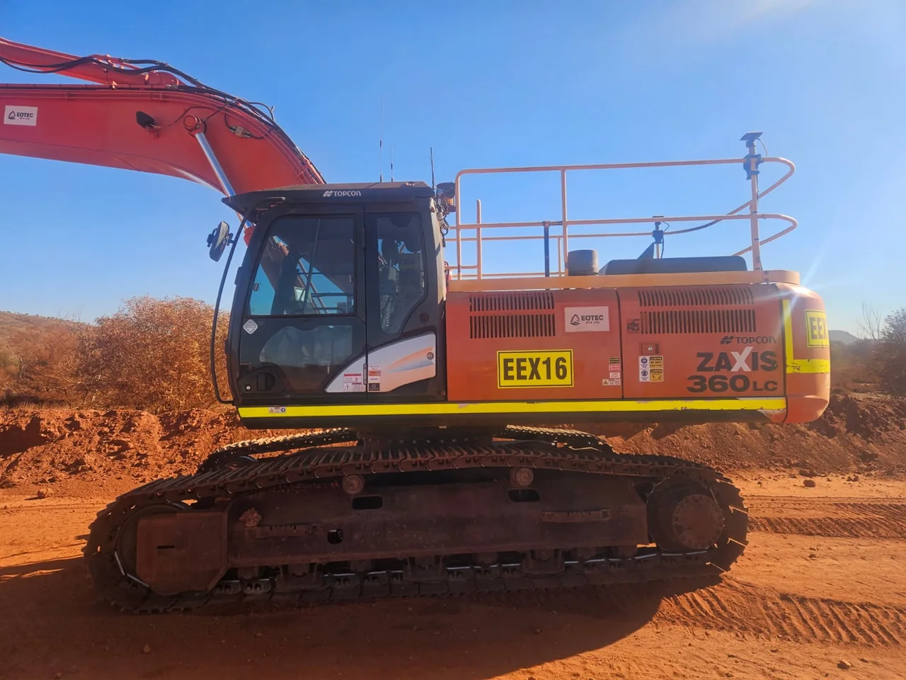 Orange EOTEC excavator outdoors on an earthmoving site, with its EEX16 identification visible.