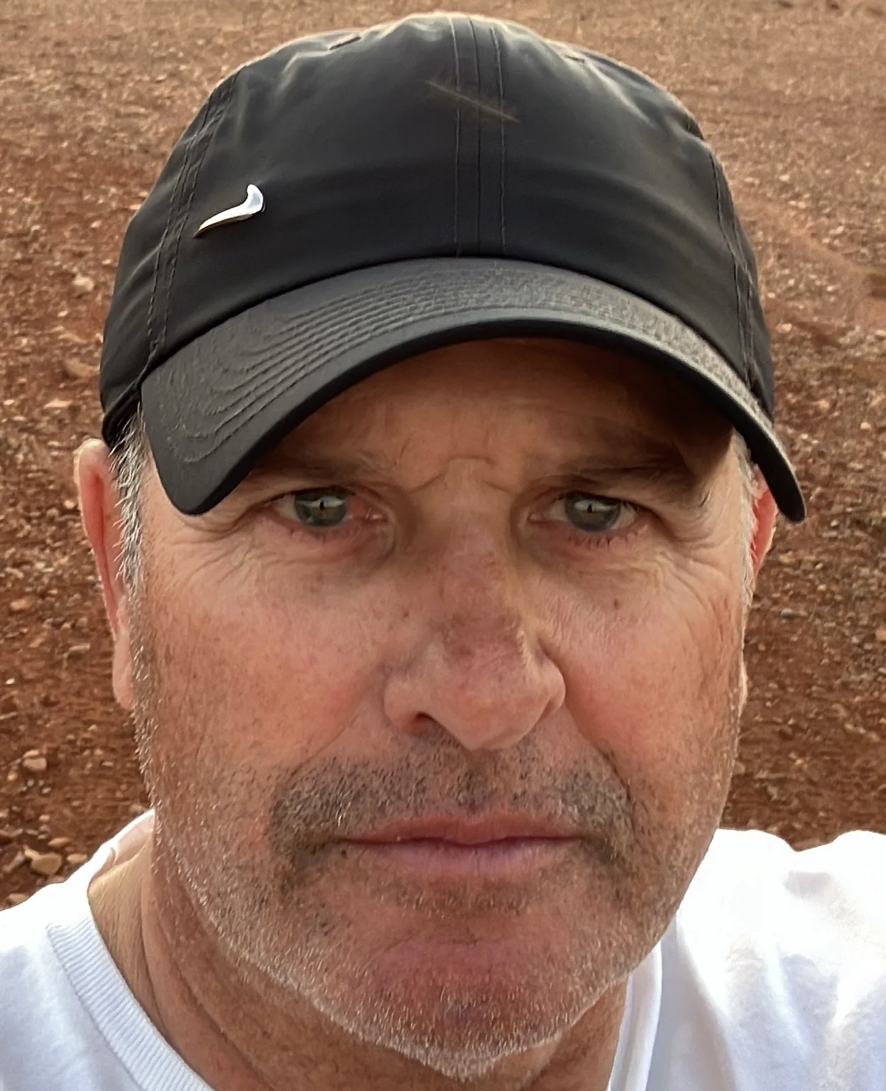 Close portrait of Tim Weir, founder of TenAdapt, wearing a black cap outdoors.